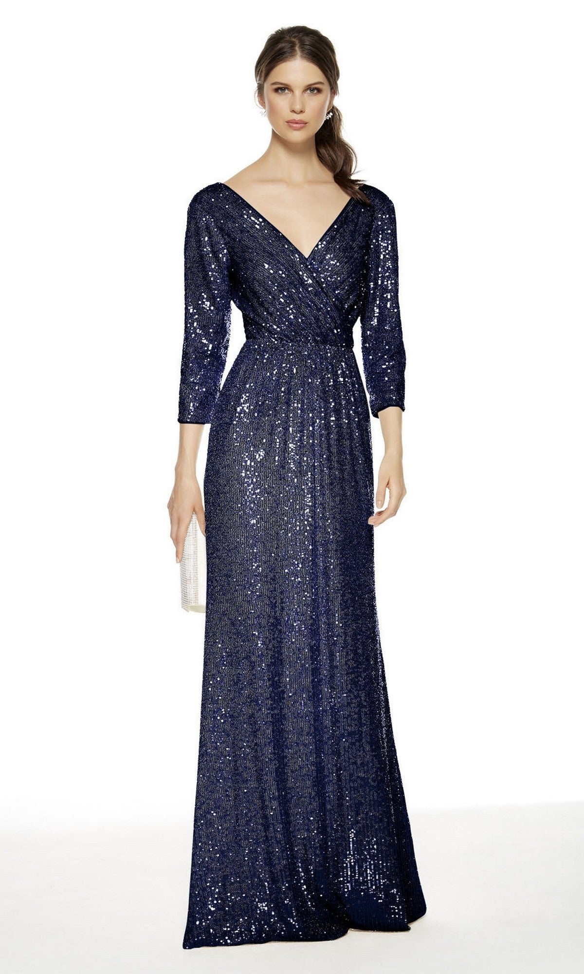 A woman wears the Alyce 27358 long formal dress in navy, featuring sequins, three-quarter sleeves, and a V-neckline—an ideal mother of the bride gown—while holding a small clutch purse.